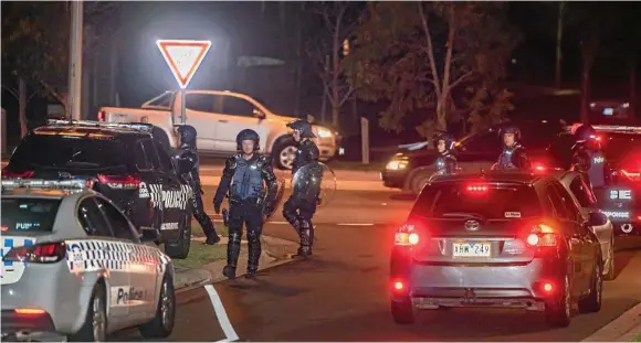  ?? Photo: Jason Edwards ?? POLICE PRESENCE: Dozens of police, including some in riot gear, gather in Taylors Hill, Melbourne, after a large group of youths wreaked havoc in the area.