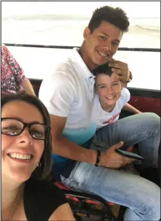  ?? COURTESY OF TRACY POFF ?? Future Rockies shortstop Ezequiel Tovar hugs Mason Poff as they take a tour of Boise, Idaho, on the city trolly in the summer of 2019. In the foreground is Tracy Poff.