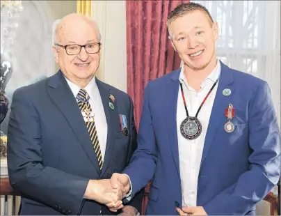  ?? SUBMITTED PHOTO ?? Lieutenant Governor Arthur J. LeBlanc, left, shakes the hand of Jaime Battiste during a ceremony at Government House. Battiste received the Sovereign’s Medal for Volunteers on Thursday in Halifax for his volunteer efforts to advance and educate others...