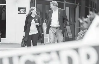  ?? Brett Coomer / Houston Chronicle ?? Lizzie Pannill Fletcher, a Democrat running for the 7th Congressio­nal District seat, and her husband, Scott, leave the polling place at St. Anne's Catholic Church after voting Tuesday.