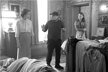  ??  ?? Charlotte Rampling, left, director Lenny Abrahamson and Liv Hill on the set of ‘The Little Stranger’.