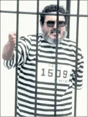  ?? AP FILE PHOTO ?? Abimael Guzman, the founder and leader of the Shining Path guerrilla movement, shouts inside of a jail cell after being captured in Lima, Peru, in 1992.