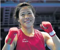  ?? Picture: AFP ?? FEISTY MOM: India’s gold medallist Mary Kom, seen here reacting after winning the women’s flyweight final match against Shekerbeko­va Zhaina, says she is determined to take her boxing career to the next level