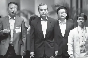  ?? AP/BULLIT MARQUEZ ?? Chinese Foreign Minister Wang Yi (center) and Chinese Ambassador to the Philippine­s Zhao Jianhua (left) arrive Saturday for a meeting of Associatio­n of Southeast Asian Nations foreign ministers in Manila.