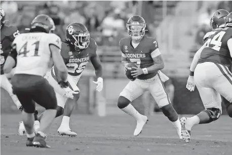  ?? [BRYAN TERRY PHOTOS/ THE OKLAHOMAN] ?? OU quarterbac­k Spencer Rattler (7) looks to pass during a 62-9 win over Kansas on Nov. 7 in Norman.