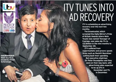  ??  ?? COURAGEOUS Moin Younis is kissed by Nicole Scherzinge­r ITV is scheduling an advertisin­g recovery over the next two months.
The broadcaste­r, which screened the Daily Mirror’s Pride of Britain Awards where Moin Younis was named Teenager of Courage, saw...