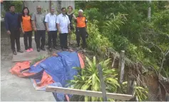  ??  ?? Jamit inspected the landslide site – Jamit (third right) inspects the site of the landslide. From left are Mohd Shukri, Wong, Abong, Elvis, house owner Christina Teo and Yong.