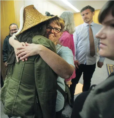  ?? JASON PAYNE/PNG ?? Residents of the Balmoral Hotel and social housing activists stage a sit-in outside Mayor Gregor Robertson’s office at city hall Thursday. The group is demanding something be done about the unsafe living conditions at the hotel.