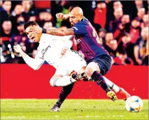  ?? JOSEP LAGO/AFP ?? Barcelona’s Arturo Vidal (right) vies with Real Madrid’s Casemiro during the Copa del Rey semi-final first leg at the Camp Nou stadium in Barcelona on Wednesday.