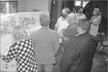  ?? Doug Walker ?? Community leaders look over renderings related to a conceptual plan for Rome’s River District during a public meeting Tuesday night.