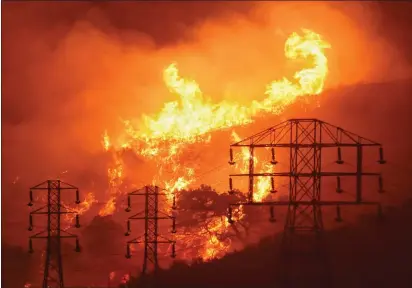  ?? MIKE ELIASON — SANTA BARBARA COUNTY FIRE DEPARTMENT FILE ?? Flames burn near power lines in Sycamore Canyon near West Mountain Drive in Montecito.