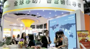  ?? CHINA DAILY A QING / FOR ?? The booth of YeahMobi — China’s leading mobile marketing company — at the Global Mobile Internet Conference in Beijing.