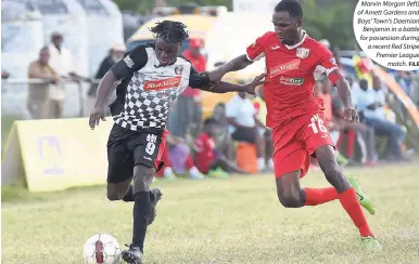  ?? FILE ?? Marvin Morgan (left) of Arnett Gardens and Boys' Town's Daemion Benjamin in a battle for possession during a recent Red Stripe Premier League match.