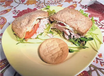  ?? EDDIE MOORE/JOURNAL ?? The Mucho Turkey Plus sandwich at Mucho in Santa Fe is served with a compliment­ary cookie.