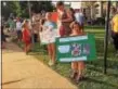  ?? SUBMITTED PHOTO ?? Residents hold signs during the “climate action rally” outside township building in Haverford this week. Later asked commission­ers to pass a resolution asking Congress to address climate change. And they are asking the township to evaluate progress and...