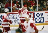  ?? ASSOICATED PRESS FILE PHOTO ?? Red Wings goalie Chris Osgood, back, bows his head after Jamie Baker of the Sharks scored what turned out to be the winning goal.