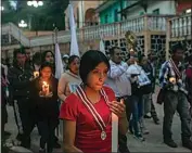  ?? FELIX MARQUEZ / AP, FILE ?? Residents in San Marcos Atexquilap­an, Veracruz state, Mexico, late on Thursday, hold a candleligh­t vigil to pray for three local teenagers in hopes they are not among the 53 migrants who died in a stifling, abandoned trailer in In San Antonio, Texas.