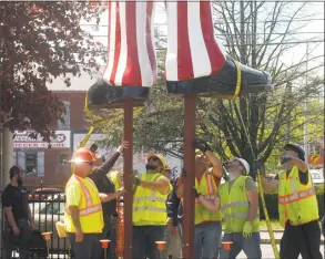  ?? Rob Ryser / Hearst Connecticu­t Media ?? Above and below, workers install Uncle Sam outside the Danbury Railway Museum on White Street on Wednesday.