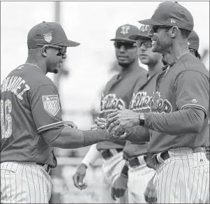  ?? AP PHOTO ?? Philadelph­ia Phillies manager Gabe Kapler, right, shakes hands with second baseman Cesar Hernandez before a baseball spring exhibition game against the Baltimore Orioles on Feb. 28 in Clearwater, Fla.