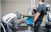  ?? [AP PHOTO] ?? Virta Woodard, a 56-year-old diabetic, chats with wellness coach Ryan Manuwa while exercising at Nifty After Fifty fitness centers, July 16 in Lakewood, Calif.