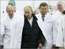  ?? ALEXEI DRUZHININ, SPUTNIK, KREMLIN POOL PHOTO VIA AP, FILE ?? In this 2010 photo, Yevgeny Prigozhin, left, shows Russian Prime Minister Vladimir Putin, second left, around his factory which produces school meals, outside St. Petersburg, Russia. Progozhin is known as “Putin’s chef” — a wealthy Russian businessma­n...