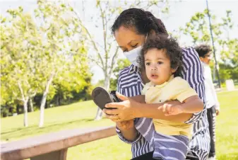  ?? Santiago Mejia / The Chronicle ?? MOM OF FIVE: Paulina Barajas fixes a shoe for her 2-year-old son, Esau, at Heather Farm Park in Walnut Creek. With five sons in her family, it’s a constant struggle to keep everyone clothed and fed.