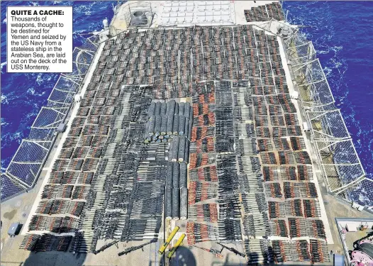  ??  ?? QUITE A CACHE: Thousands of weapons, thought to be destined for Yemen and seized by the US Navy from a stateless ship in the Arabian Sea, are laid out on the deck of the USS Monterey.