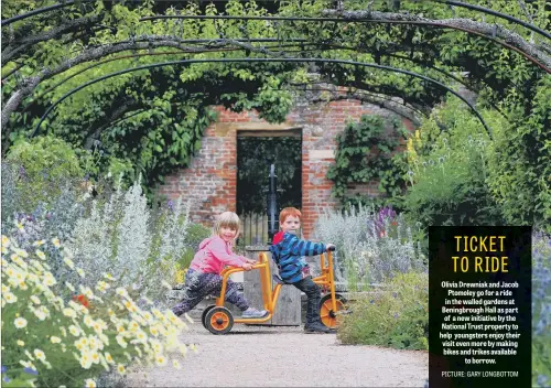  ??  ?? Olivia Drewniak and Jacob Ptomoley go for a ride in the walled gardens at Beningbrou­gh Hall as part of a new initiative by the National Trust property to help youngsters enjoy their visit even more by making bikes and trikes available to borrow.