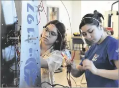  ?? SHARON BURNS PHOTO ?? Two Central Union High School Robotics Club members fix some wiring on their robot during an on campus practice session, Saturday, March 18, in El Centro.