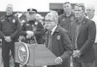  ?? DISPATCH ADAM CAIRNS/COLUMBUS ?? Surrounded by community donations, Gov. Mike Dewine speaks to media inside the Indian Lake High School gym after a tornado struck the area the night before.