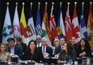  ?? DARRYL DYCK, THE CANADIAN PRESS ?? Federal Minister of Justice and Attorney General Jody Wilson-Raybould, centre left, is flanked by Deputy Minister of Justice Nathalie Drouin, left, and Alberta Minister of Justice and Solicitor General Kathleen Ganley, right, at a meeting of federal, provincial and territoria­l ministers in Vancouver, B.C., on Thursday.