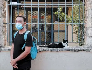  ?? THANASSIS STAVRAKIS THE ASSOCIATED PRESS ?? Actor and theatre director Aris Laskos poses outside the Theater of Neos Kosmos in Athens Thursday. Laskos hasn’t worked since early February.