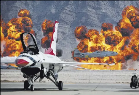  ??  ?? A Lockheed T-33 Ace Maker II performs as pyrotechni­cs go off during the Aviation Nation air show.