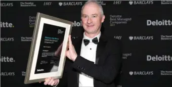  ??  ?? Group Financial Director of TLI Joe Rogers with the Platinum award from Deloittes on the Kerry firm being named one of the country’s best-managed companies.