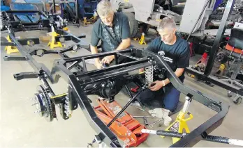  ?? ALYN EDWARDS ?? Ewald and Kurt Penner of Jellybean AutoCrafte­rs and Customs work on a frame for a 1954 Studebaker restomod that will take an estimated 2,500 hours to complete.