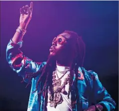  ??  ?? A MEMBER of the festival-jumping rap group Migos prowls the stage during a Sunday set at the two-day event, which drew some 80,000 fans.