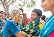  ?? AP ?? A boy whose mother died after eating temple food in Karnataka being consoled by his grandmothe­r.
