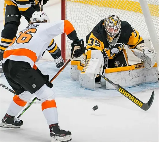 ?? INSIDE: Peter Diana/Post-Gazette ?? Tristan Jarry made 40 saves Tuesday in a game in which the Penguins were outshot, 42-27. He makes one here against Philadelph­ia’s Joel Farabee. The latest on Sidney Crosby, Page D-3.