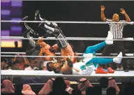  ?? Associated Press ?? Seth Rollins and Murphy, left and center, in action against The Street Prophets at WWE Super ShowDown in Riyadh, Saudi Arabia, in February.