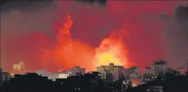  ?? AFP ?? Smoke towers above a huge fire following Israeli airstrikes on multiple targets in Gaza City early on Sunday.