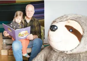  ?? JOCELYN LEE/THE NEW YORK TIMES ?? Hector Jaeger reads with his granddaugh­ter Jan. 11 in Bath, Maine. Jaeger became a stay-at-home dad in 1990.