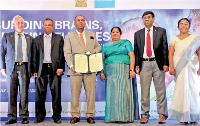  ??  ?? The Minister of Finance accepts proposals to increase funding. (From left) - Tim Sutton (Representa­tive, UNICEF Sri Lanka); K.D.S. Ruwanchand­ra (Secretary, Ministry of National Policies and Economic Affairs; Mangala Samaraweer­a (Minister of Finance and Mass Media); Ms. Ashoka Alawatte (Secretary, Ministry of Women and Child Affairs); Janaka Sugathadas­a (Secretary, Ministry of Health, Nutrition and Indigenous Medicine) and Ms. Badra Vithanage (Director – Education for All Branch of the Ministry of Education)