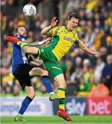  ?? —Reuters ?? Up where we belong: Norwich’s Christoph Zimmermann (right) in action with Sheffield Wednesday’s Steven Fletcher during their Championsh­ip match on Friday.