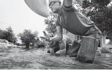  ?? Robert Cohen / Associated Press ?? Missouri National Guardsmen shore up a sandbag wall in Clarksvill­e, near the Mississipp­i River.