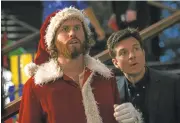  ?? PARAMOUNT PICTURES ?? T.J. Miller’s Clay, left, and Jason Bateman‘s Josh Parker undertake an important task in “Office Christmas Party.”