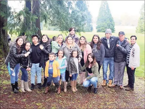  ?? Associated Press ?? In this undated photo provided by Melissa Espinoza, Raul Espinoza Gomez, second from right, poses for a photo at Remlinger Farms in Carnation, Wash., where the majority of the family works. He’s pictured with some of his 22 grandchild­ren and great-grandchild­ren. Gomez has an appointmen­t Saturday for his second dose of coronaviru­s vaccine and by Easter, the 77-year-old's immune system will be ready to protect him from the virus. But how the family celebrates will depend on government advice, Melissa Espinoza said.