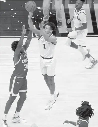  ?? ANDYLYONS/GETTY ?? Gonzaga’s Jalen Suggs launches a game-winning three-pointer in overtime to defeat UCLA 93-90 during a national semifinal Saturday at Lucas Oil Stadium in Indianapol­is.