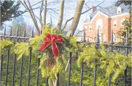  ??  ?? Wreaths decorate the spiked fence ringing the Government House, which is celebratin­g 150 years of serving as the home of Maryland governors today.