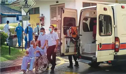  ??  ?? On safer ground: Patients being brought out from the ward that had caught fire at Hospital Sultanah aminah in Johor Baru. all patients were evacuated and transferre­d to a nearby hospital.