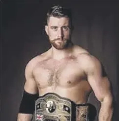  ??  ?? Joe Hendry with his Elite Wrestling belt, won during his pro days.